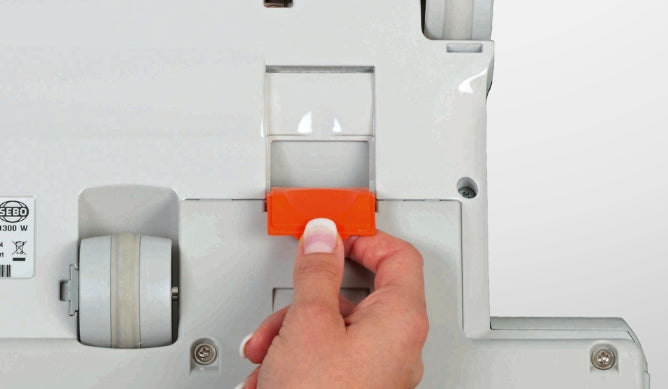 Check for clogs using the trap door on the bottom